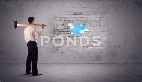 Business man hitting brick wall with hammer Stock Photos