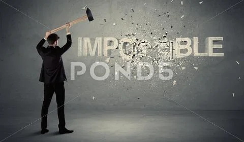 Business man hitting impossible sign with hammer Stock Photos