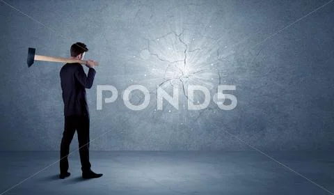 Business man hitting wall with a hammer Stock Photos