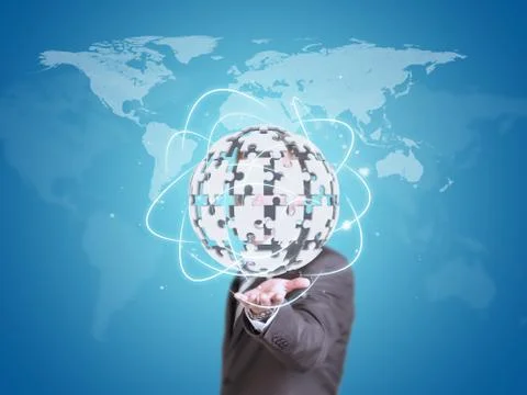 Business man hold exploding ball of gray puzzle pieces 스톡 사진