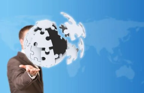 Business man hold exploding ball of gray puzzle pieces 스톡 사진