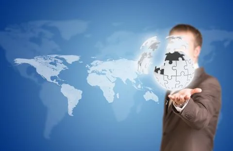 Business man hold exploding ball of gray puzzle pieces 스톡 사진