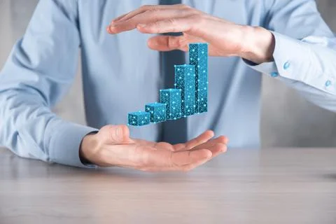 Business man holding 3D graphs low polygonal and stock market statistics gain Stock Photos