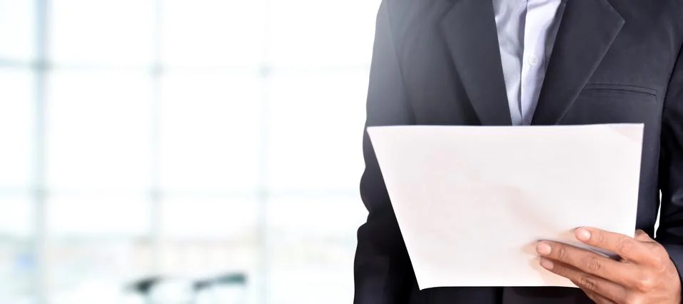 The business man is holding the paper in the office Stock Photos