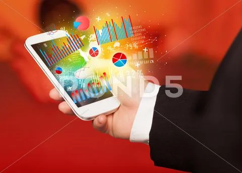 Business man holding smartphone with chart symbols Stock Photos