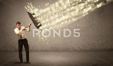 Business man holding umbrella against dollar rain concept Stock Photos