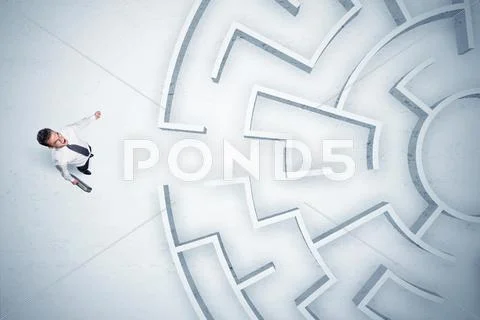 Business man looking at circular maze with nowhere to go Stock Photos