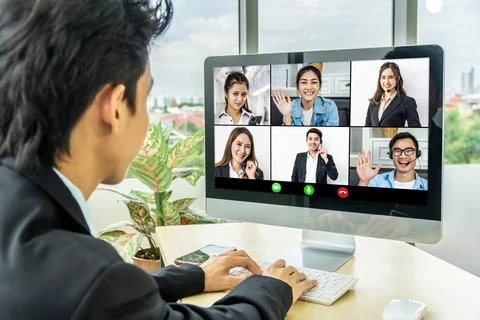 Business man looking at computer where collage of diverse people webcam view Stock Photos