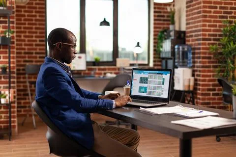 Business man looking at data chart to do stock market analysis for company Stock Photos