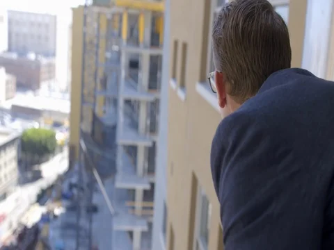 Business man looking from high window at urban landscape 4K Stock Footage 80228271