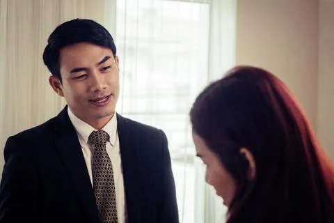 Business man looking interested while dealing with partner Stock Photos