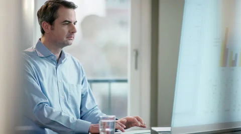 Business man looking at screen, comparing data Stock Footage 61358226