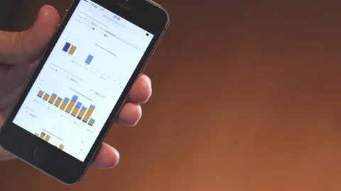 Business man looking stats in his smartphone Stock Footage 80361569