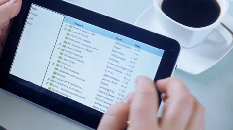 Business man looking through emails on tablet pc, Stock Footage 31913832