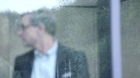 Business man looking through window Stock Footage 59386413