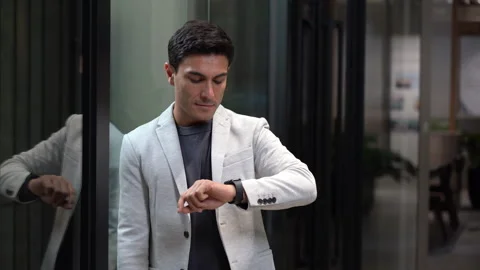Business man looking to watch checking the time in office Stock Footage 252962410