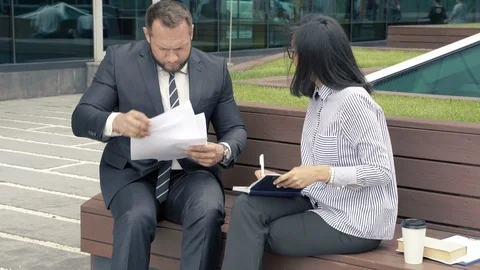 Business man manager submitting papers for signature to his boss woman Stock Footage 110748461