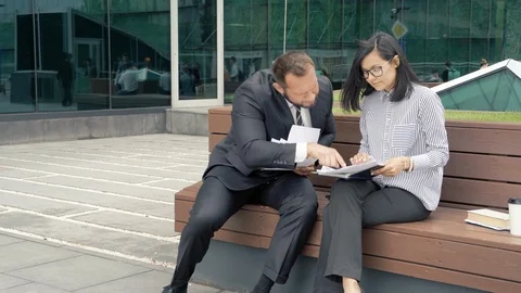 Business man manager submitting papers for signature to his strict boss woman. Stock Footage 111215059