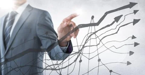 Business man mid section with pointing behind grey graph against white Foto stock