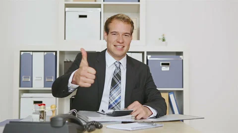 Business man in office holding thumbs up Stock Footage 32246149