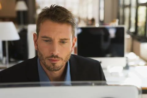 Business man in office using computer, portrait Stock Photos