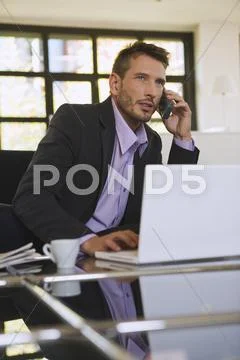 Business man in office using mobile phone, portrait Stock Photos