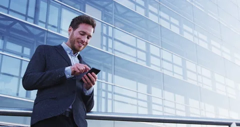 Business man on phone texting using messaging app or social media app on Stock Footage 231012309