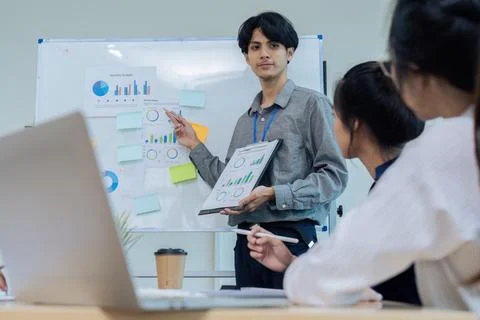 Business man present strategy plan on tablet to corporate colleagues in the Stock Photos