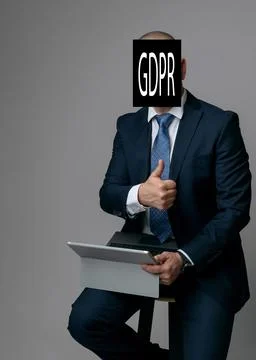 Business man processes a note with the title of data protection law and holds Stock-Fotos