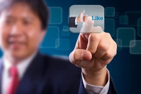 Business man push like button Stock Photos