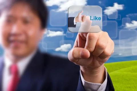 Business man push like button Stock Photos
