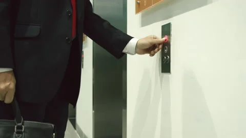 Business man pushing red button for calling elevator in modern business office Video stock 164995495