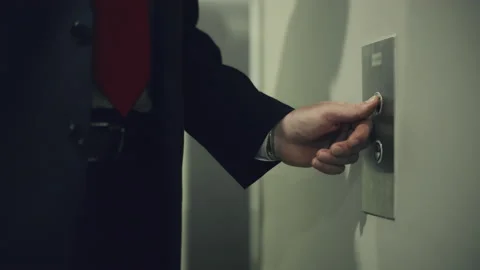 Business man pushing red button for calling elevator in modern business office Stock Footage 166636484