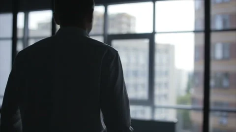 Business man puts on his jacket. Businessman dressed. Silhouette of a Stock Footage 68551851