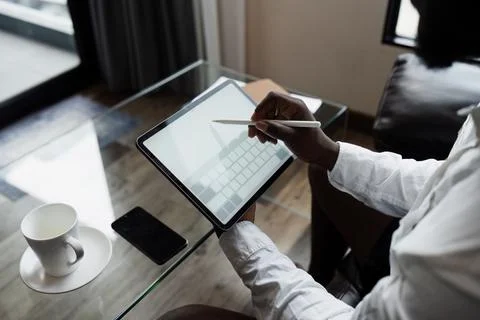 Business man Remote Work with Tablet in Modern Home Office with Coffee Cup and Foto stock