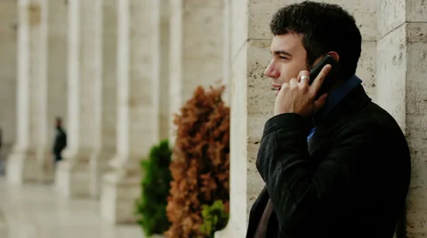 Business man on the run in city using cell phone Stock Footage 33357194