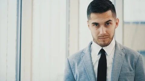 Business man is serious, looking at the camera, isolated on white blurred Stock Footage 123497958