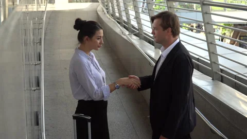 Business man shaking hands  each other with businesswoman parting to working Stock Footage 162282319