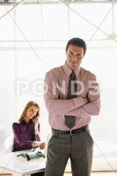 Business man in shirt and tie arms folded Stock Photos