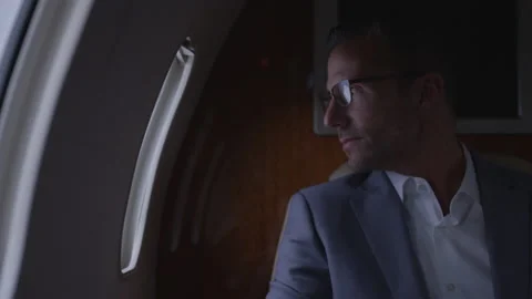 Business Man Sits Looking Out Window Of Jet Stock Footage 208714392
