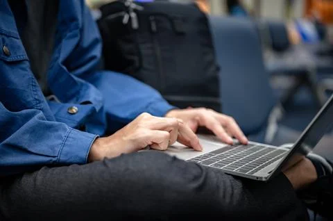 Business man sitting and using laptop computer to work at the airport, youn.. Stock Photos
