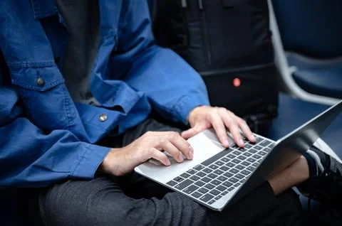 Business man sitting and using laptop computer to work at the airport, youn.. Stock Photos