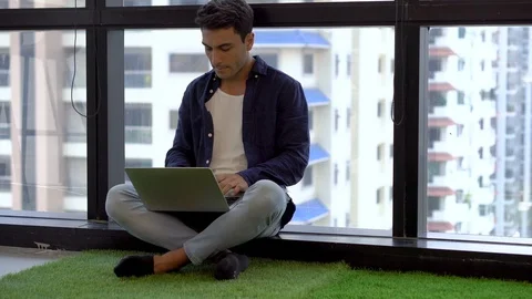 Business man sitting on Green grass at floor working with laptop computer or Stock Footage 112730010