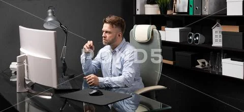 Business man sitting in office at computer Desk and holding his mouth shackle of Stock Photos