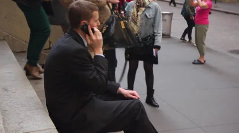 Business Man Sitting on Steps and Talking on Cellphone Vidéo 22763510