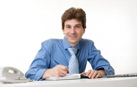 Business man smiling while working in his office Stock Photos