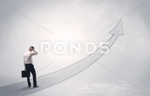 Business man standing on drawn arrow Stock Photos