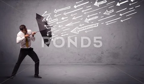Business man standing with umbrella and drawn arrows hitting him Stock Photos