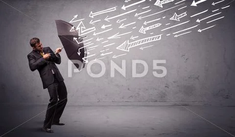 Business man standing with umbrella and drawn arrows hitting him Stock Photos