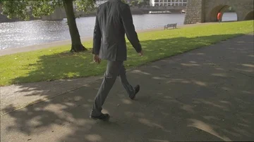 Business man in suit walking commuting to work by the river in London  Stock Footage 85669141